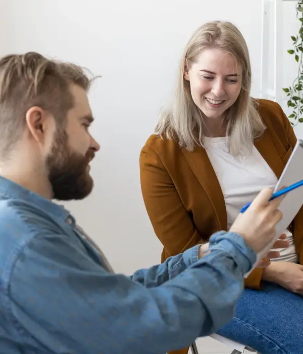 man-smiley-woman-discussing-page